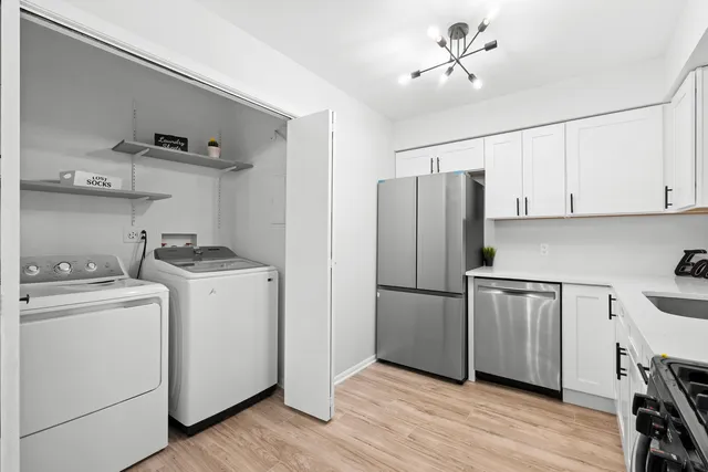 a kitchen with a refrigerator sink and cabinets
