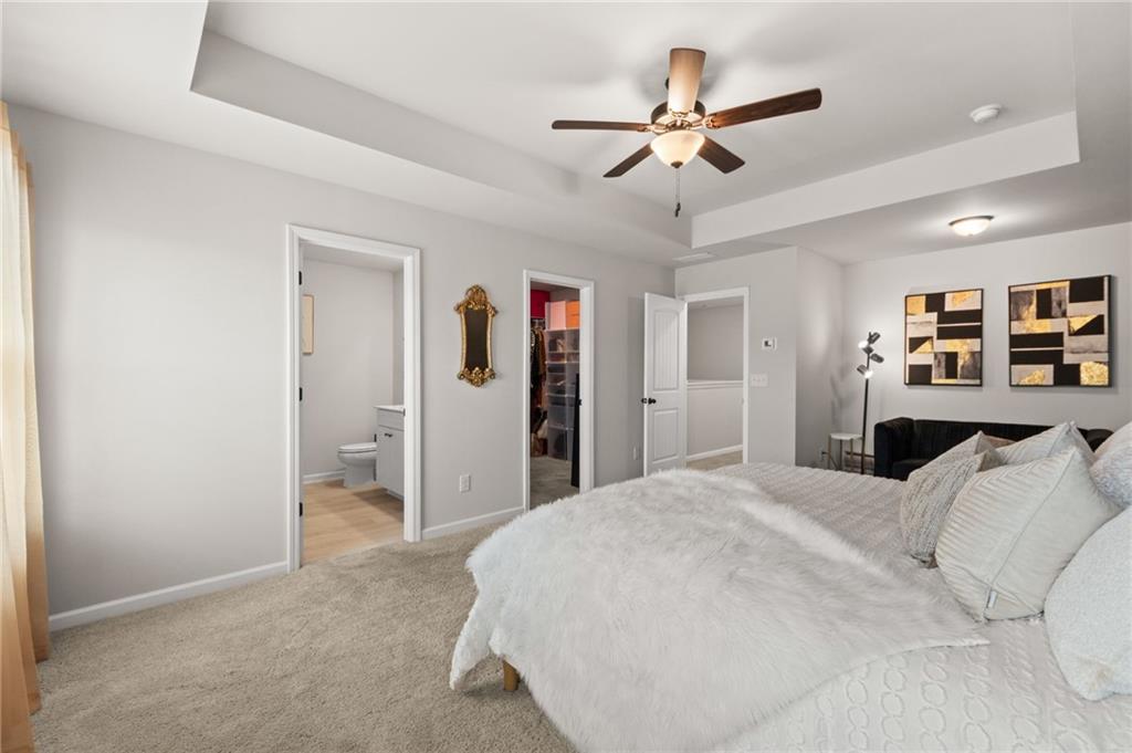 2538 Polaris Way Southwest Atlanta, GA 30331 - Photo 17 of 28 a spacious bedroom with a bed and a ceiling fan