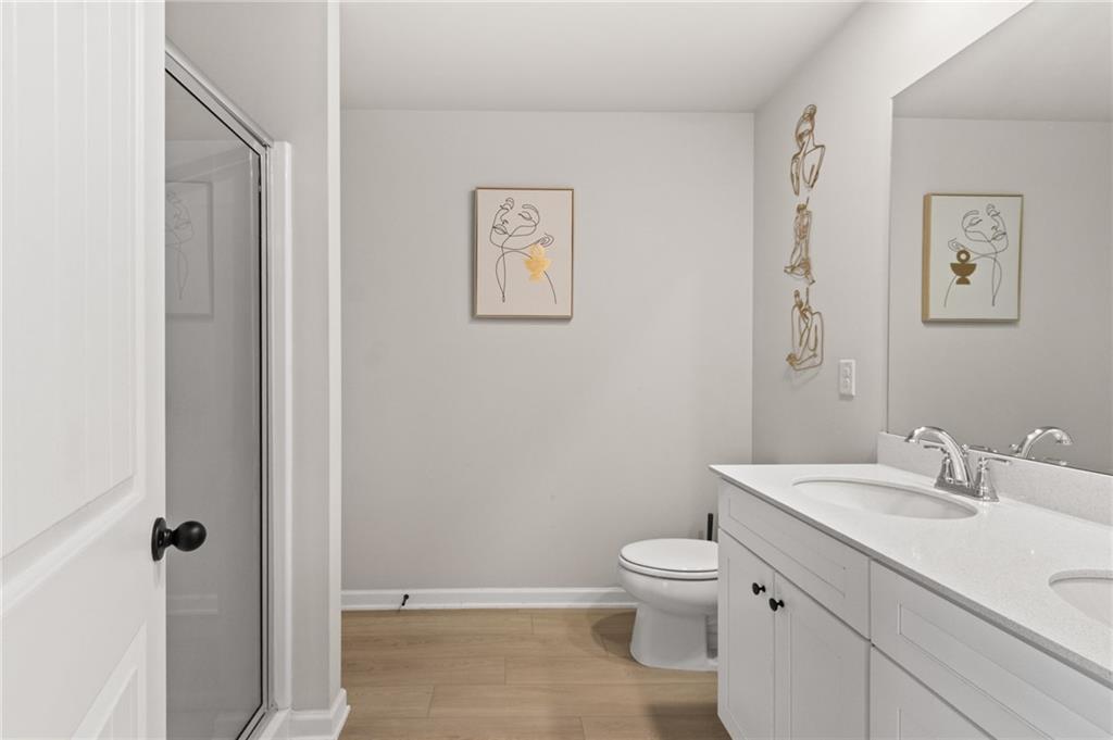 2538 Polaris Way Southwest Atlanta, GA 30331 - Photo 18 of 28 a bathroom with a toilet a sink and mirror
