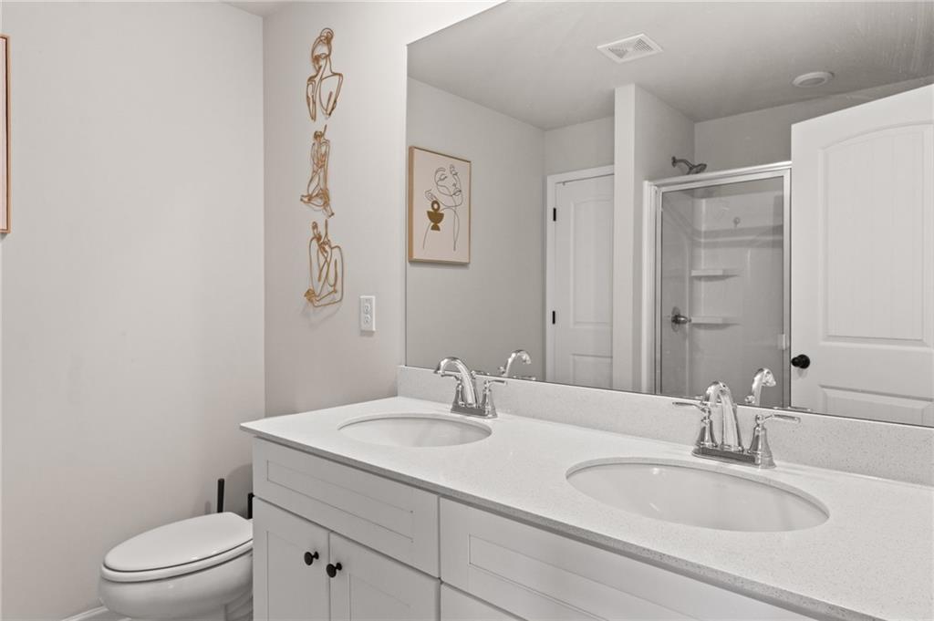 2538 Polaris Way Southwest Atlanta, GA 30331 - Photo 19 of 28 a bathroom with a granite countertop sink a toilet and a mirror