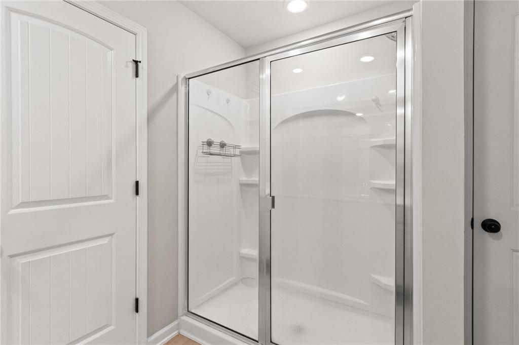 2538 Polaris Way Southwest Atlanta, GA 30331 - Photo 20 of 28 a bathroom with a glass shower door