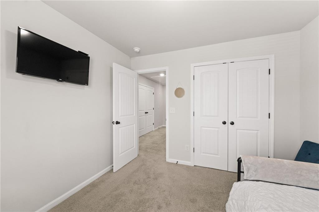 2538 Polaris Way Southwest Atlanta, GA 30331 - Photo 22 of 28 a living room with a flat screen tv and a wall painting