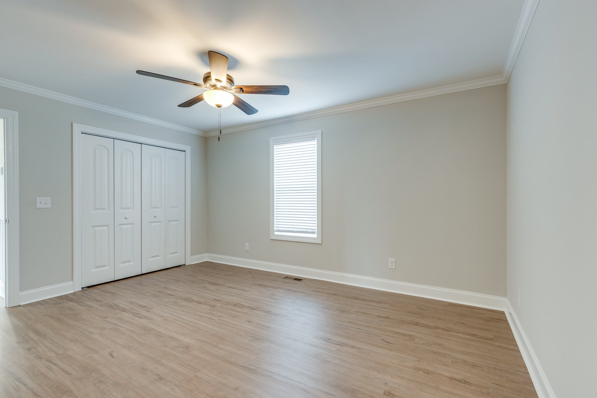 122 Fiddlers Court Pulaski, TN 38478 - Photo 14 of 27 an empty room with wooden floor ceiling fan and windows