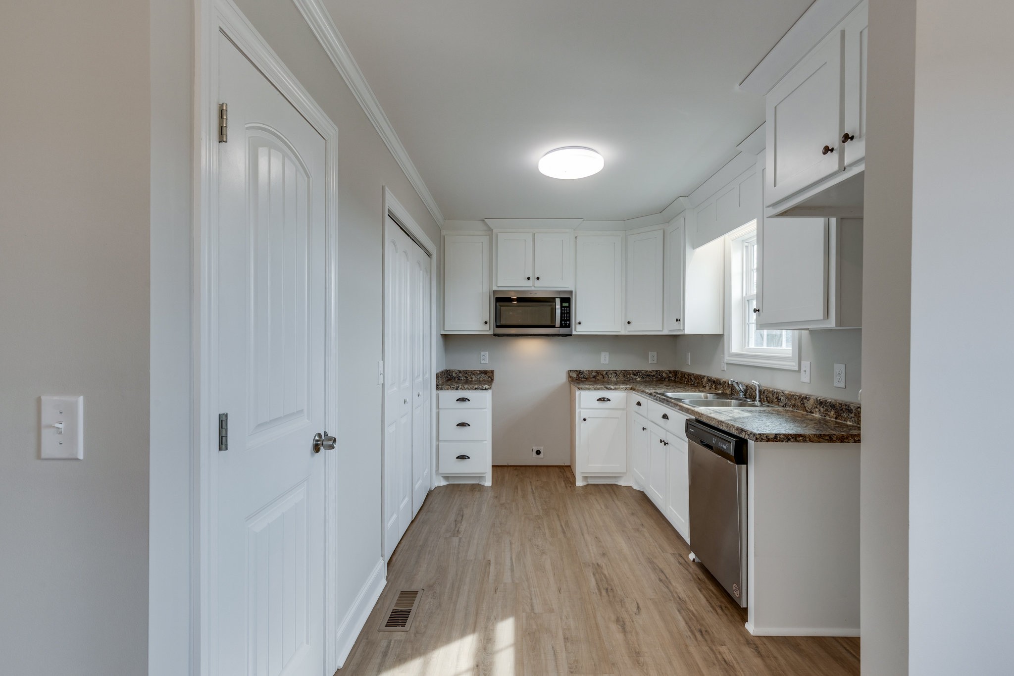 122 Fiddlers Court Pulaski, TN 38478 - Photo 10 of 27 a kitchen with cabinets wooden floor and stainless steel appliances