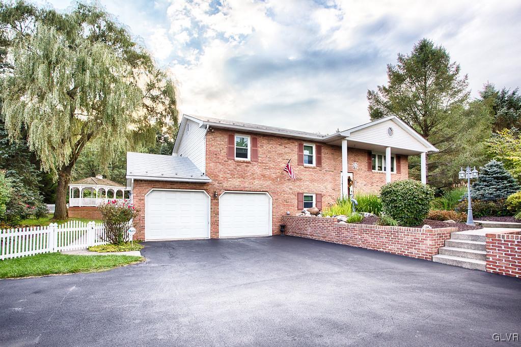 989 Park Estates Road Wind Gap, PA 18091 - Photo 1 of 41 a front view of a house with a yard and garage