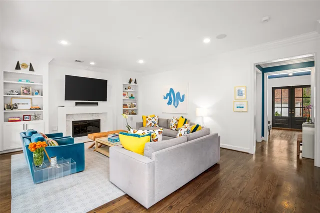 a living room with furniture a fireplace and a flat screen tv
