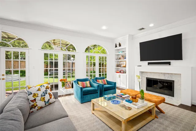a living room with furniture fireplace and a flat screen tv