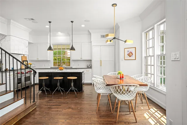 a dining room with furniture a chandelier and wooden floor