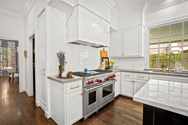 a kitchen with a stove and white cabinets