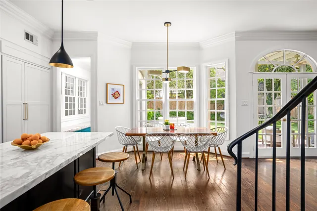 a dining room with furniture window and wooden floor