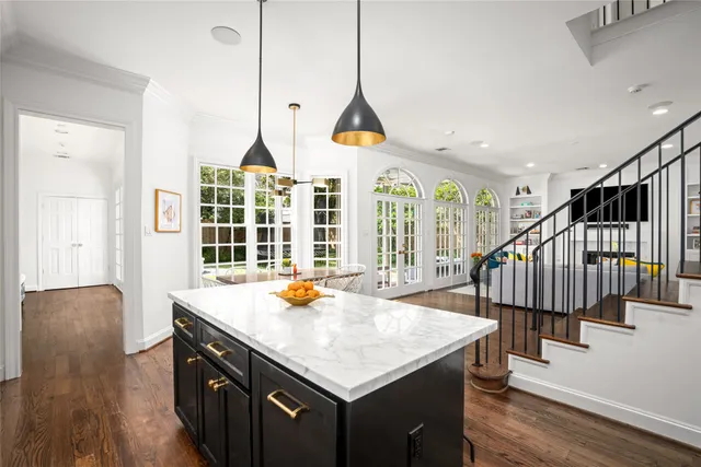 a kitchen with sink and wooden floor