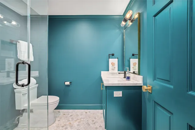 a bathroom with a toilet sink and mirror