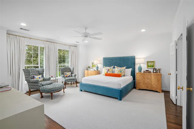 a bedroom with furniture and a flat screen tv