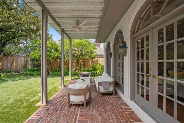 an aerial view of residential houses with outdoor space and trees