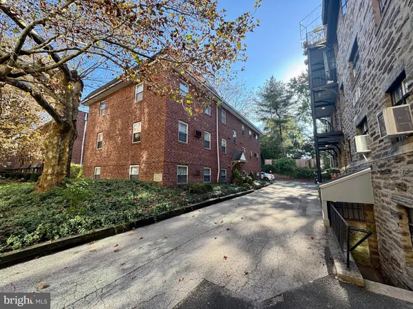 a pathway of a house with a yard
