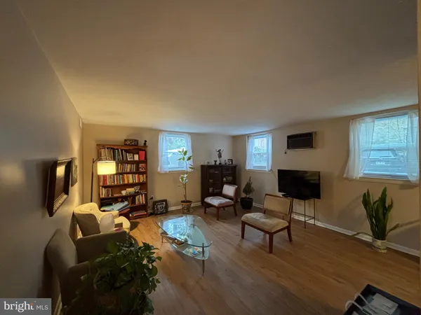 a living room with furniture window and a flat screen tv