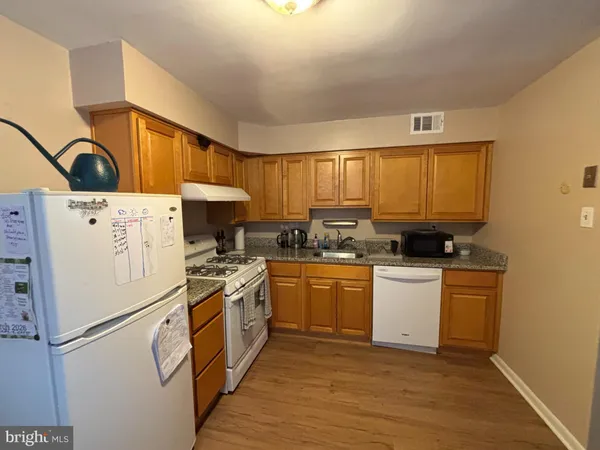 a kitchen with a sink a refrigerator and window