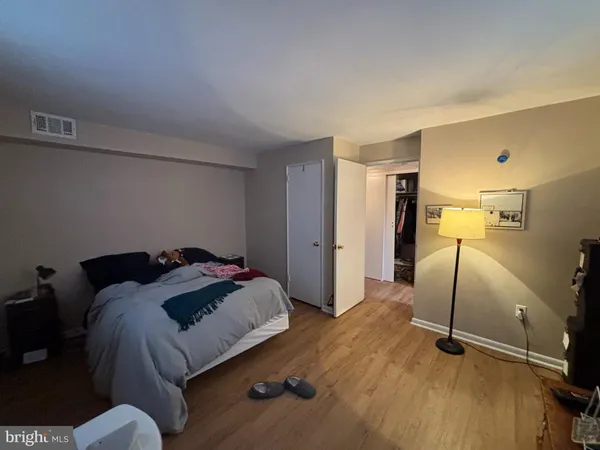 a bedroom with a bed and a dresser