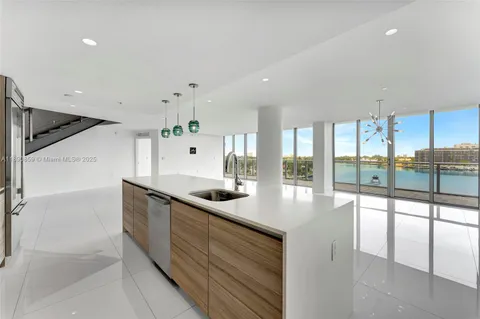 a view of a lake with houses in the back