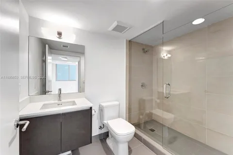 a view of a patio with table and chairs under an umbrella