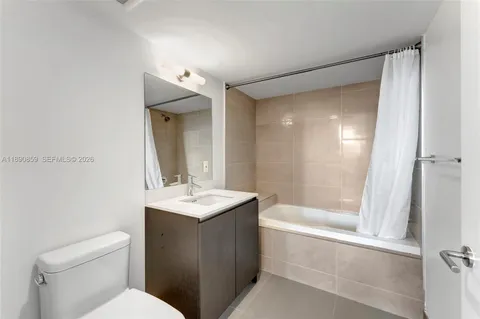 a view of empty room with wooden floor and fireplace