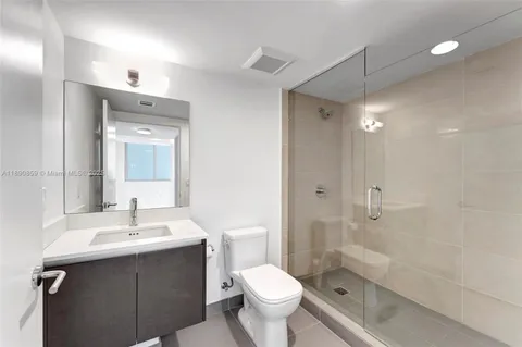 a view of empty room with wooden floor and fireplace