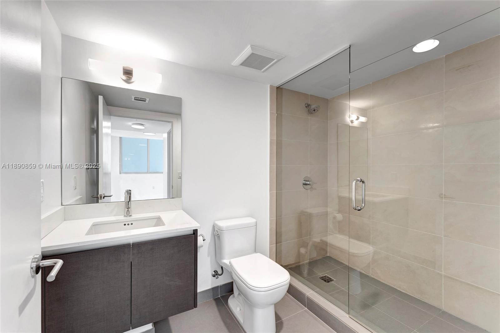 6620 Indian Creek Drive, Unit PH711 Miami Beach, FL 33141 - Photo 31 of 82 a bathroom with a sink toilet a mirror and shower