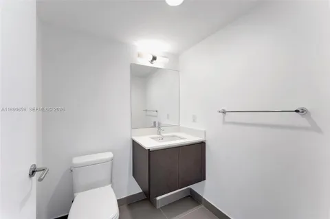 a view of empty room with wooden floor and floor to ceiling window