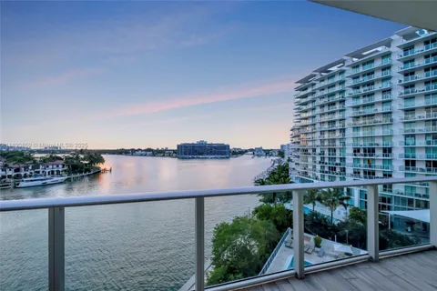 a view of wooden floor and lake from a terrace