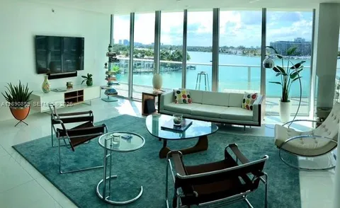 a kitchen with stainless steel appliances granite countertop a sink and a wooden floors
