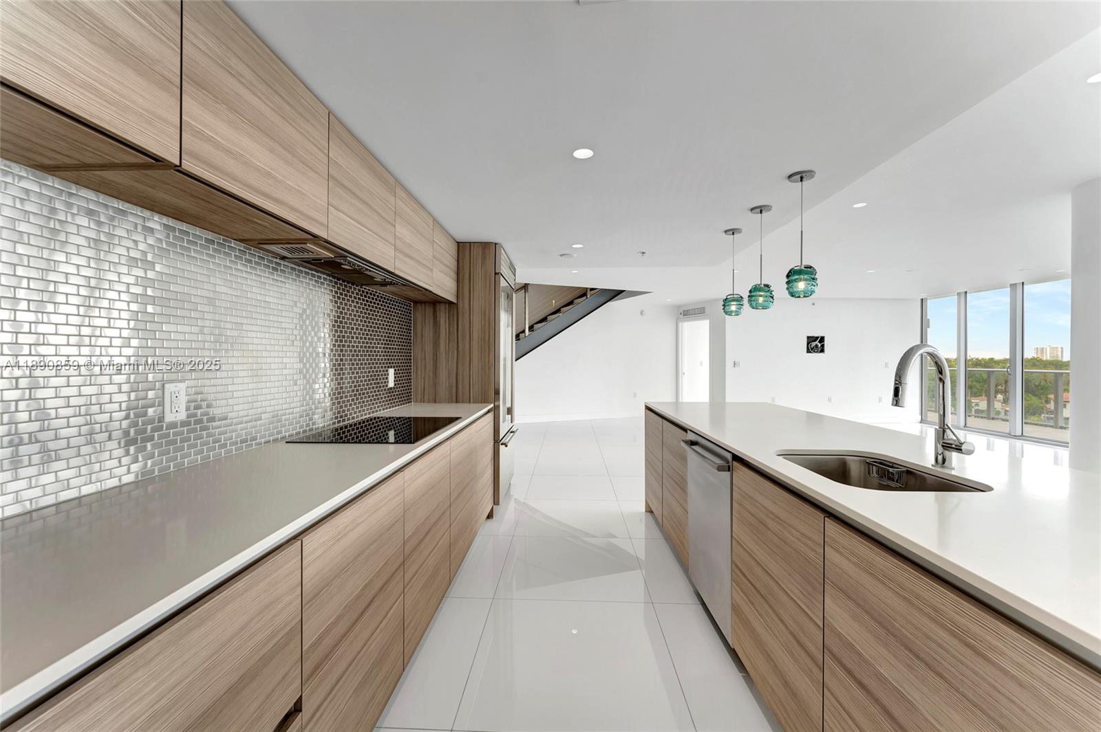 6620 Indian Creek Drive, Unit PH711 Miami Beach, FL 33141 - Photo 10 of 82 a kitchen with stainless steel appliances granite countertop a sink and a wooden floors