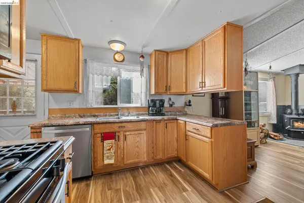 a kitchen with a stove a sink and a refrigerator