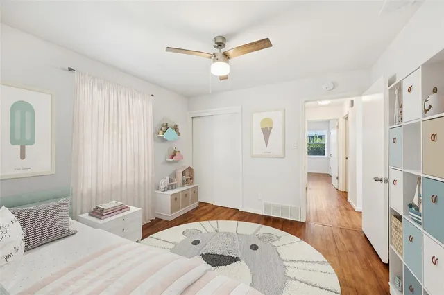 a bedroom with furniture and a wooden floor