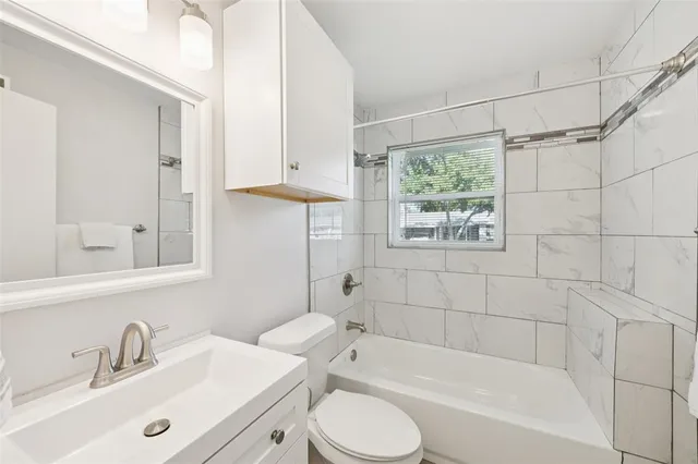 a bathroom with a sink mirror toilet and bathtub