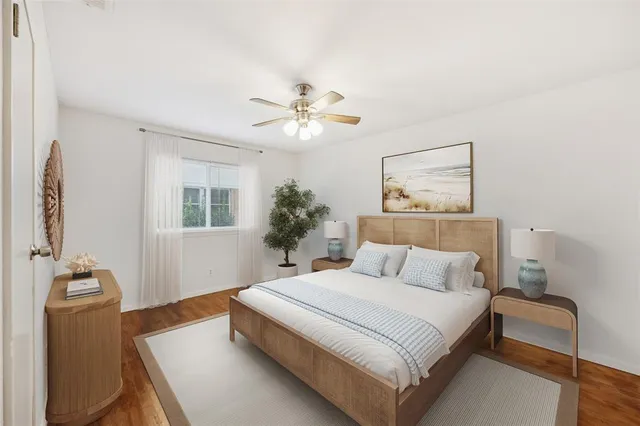 a bedroom with a large bed and a chandelier