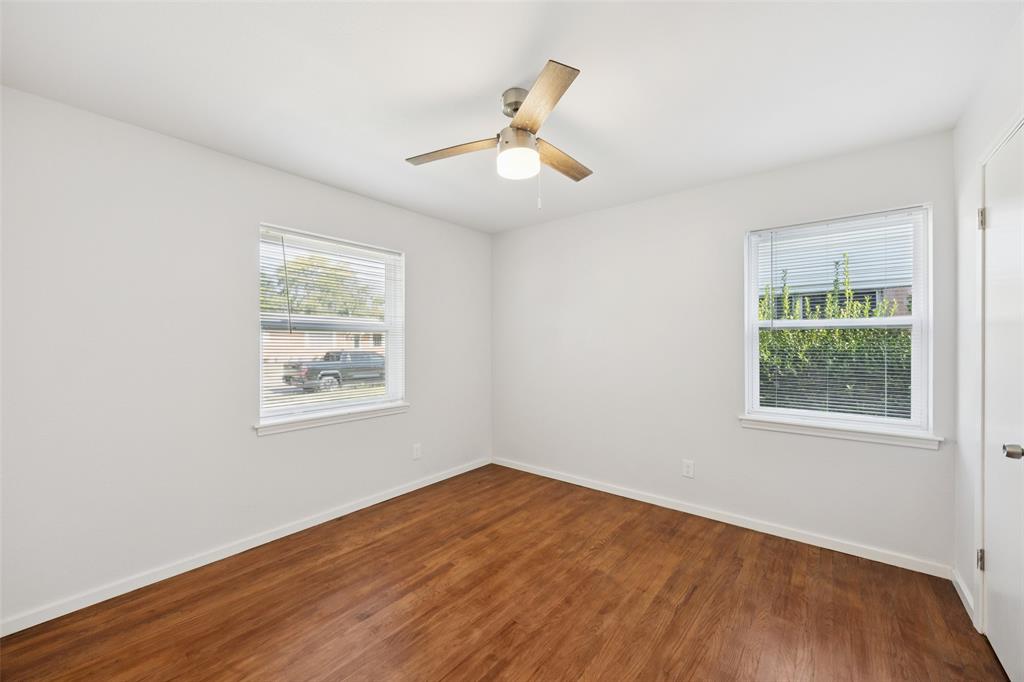 914 Royal Street Forney, TX 75126 - Photo 19 of 28 an empty room with wooden floor chandelier fan and windows