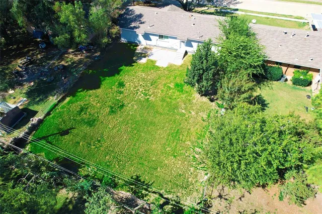 an aerial view of residential house with green space