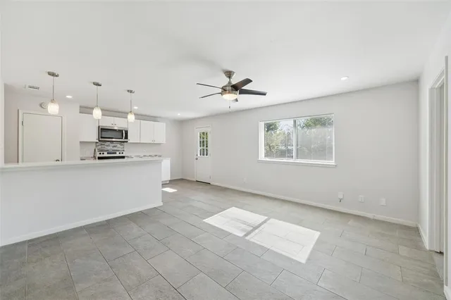 a view of kitchen with cabinets and window