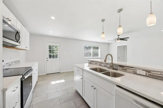 a kitchen that has a sink and a stove