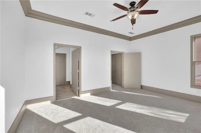 a view of a room with a ceiling fan