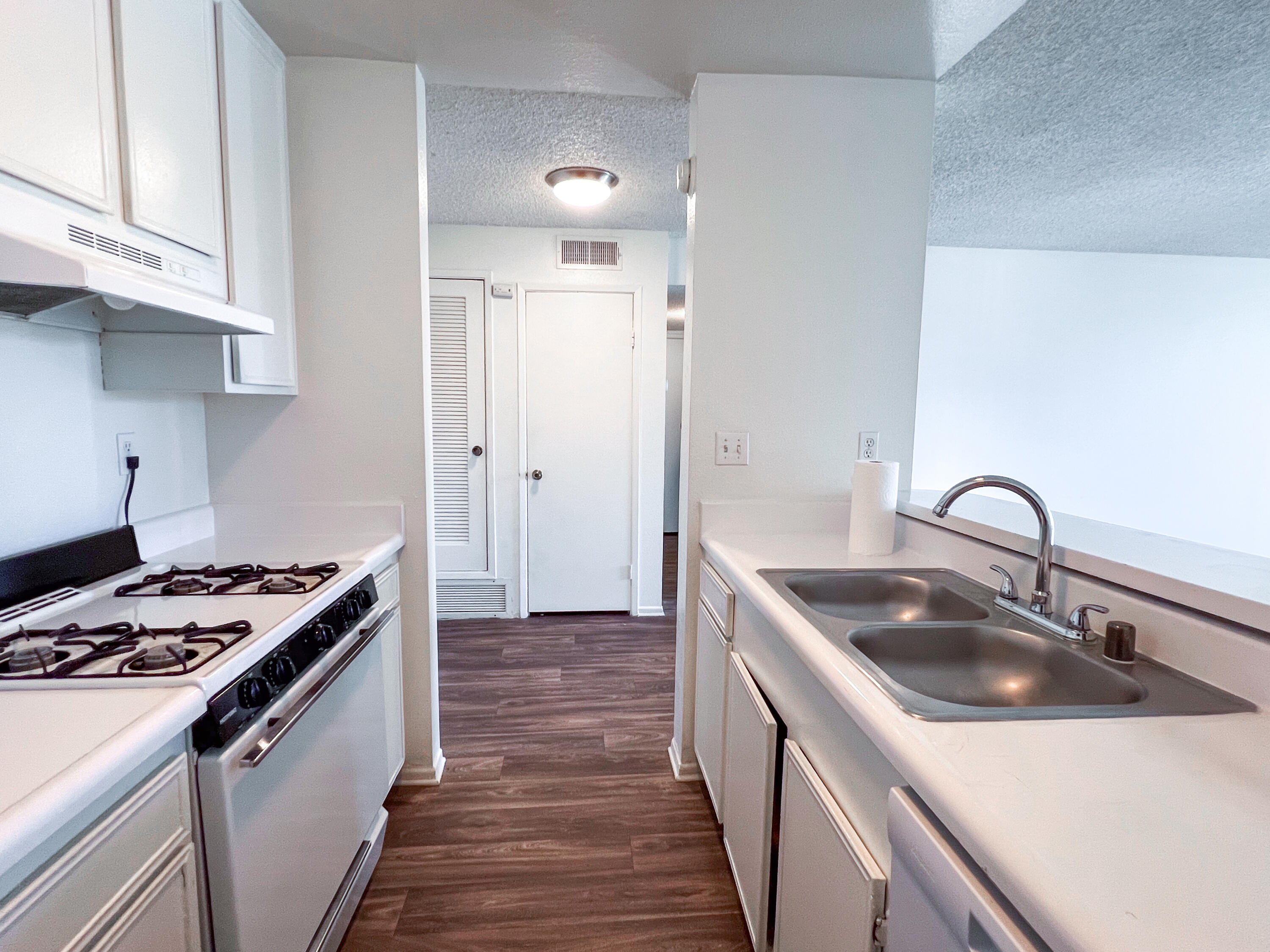 1400 East Palm Canyon Drive, Unit 109 Palm Springs, CA 92264 - Photo 5 of 14 a kitchen with sink a stove and refrigerator