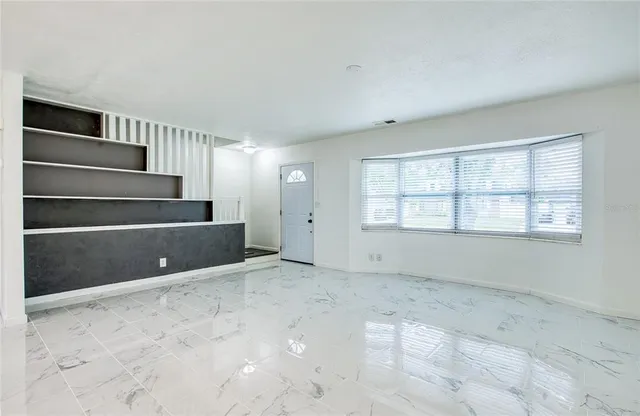 a view of an empty room with a window