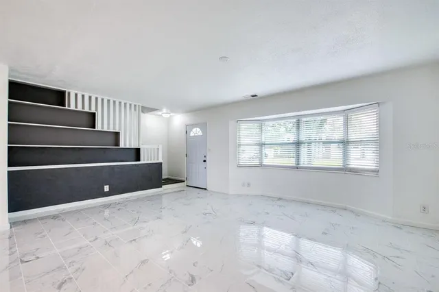 a view of an empty room with a window