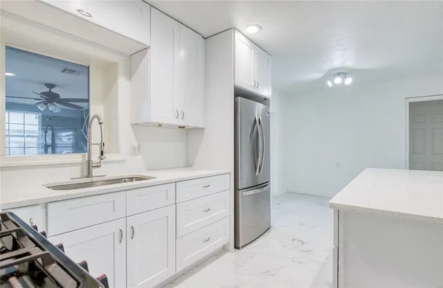 a kitchen with a sink and refrigerator