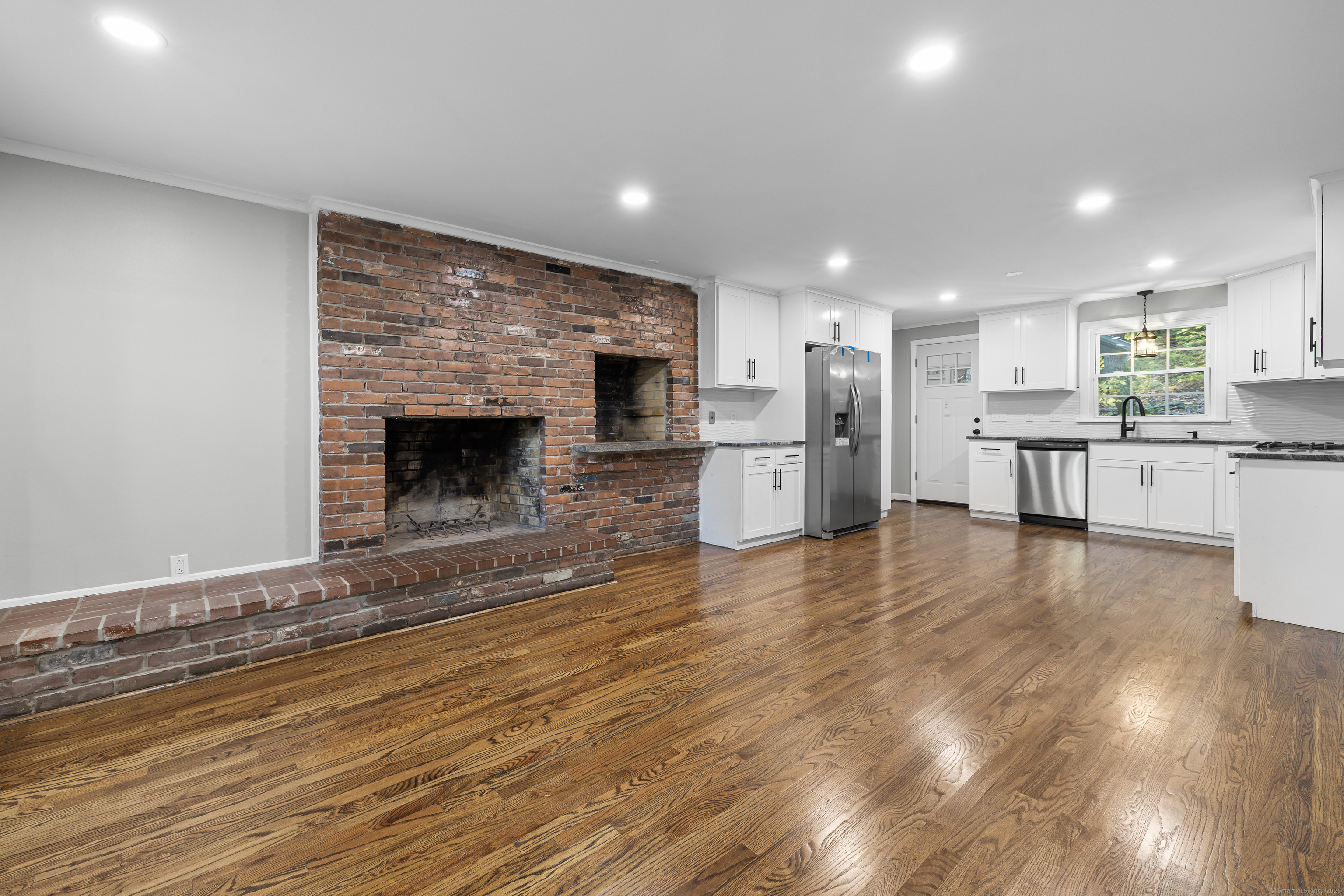a view of a kitchen with a stove cabinets and a wooden floor
