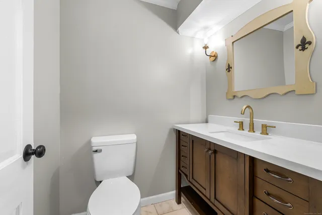 a bathroom with a toilet sink and mirror