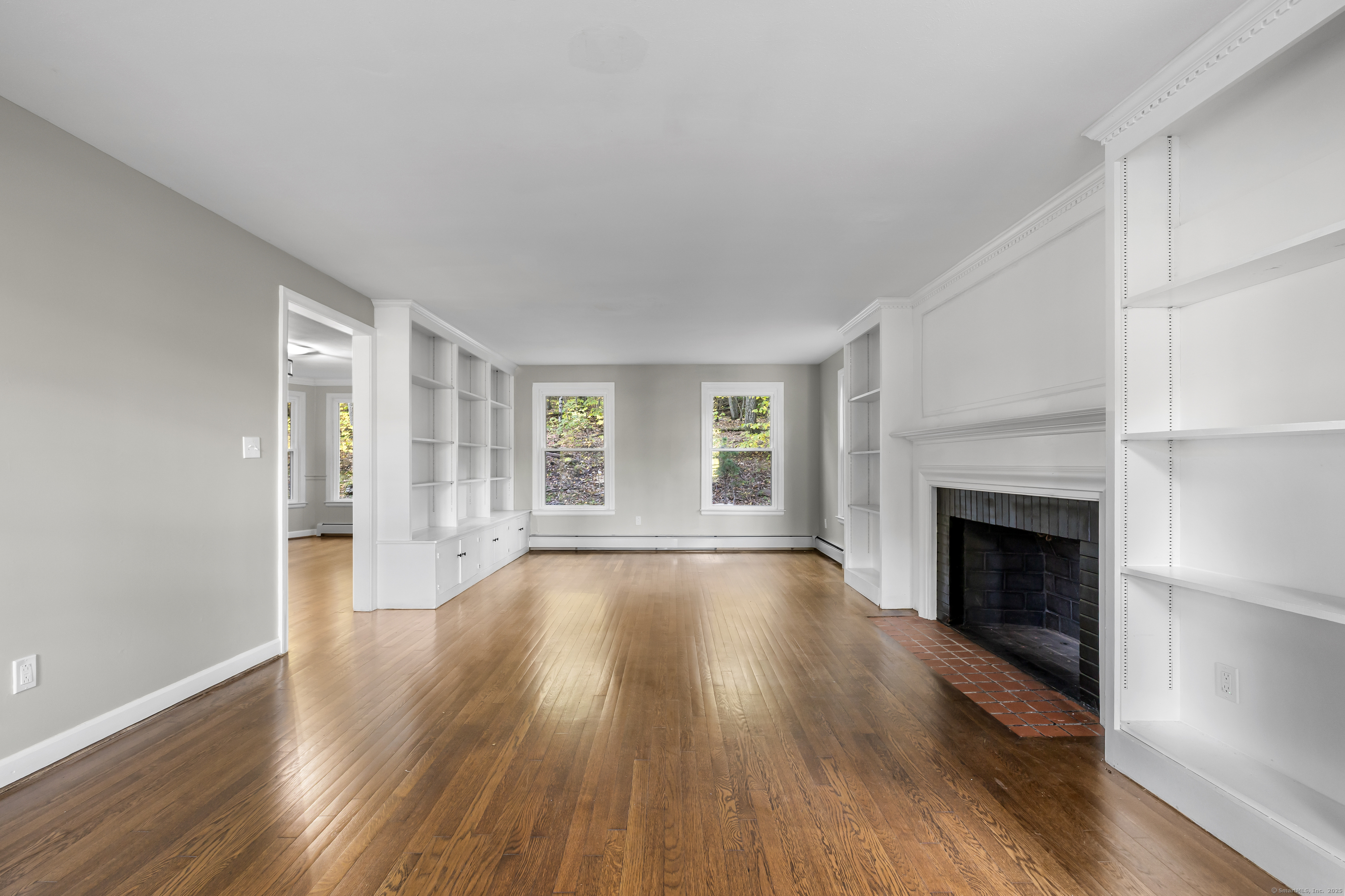545 Simsbury Road Bloomfield, CT 06002 - Photo 16 of 39 a view of an empty room with wooden floor fireplace and a window