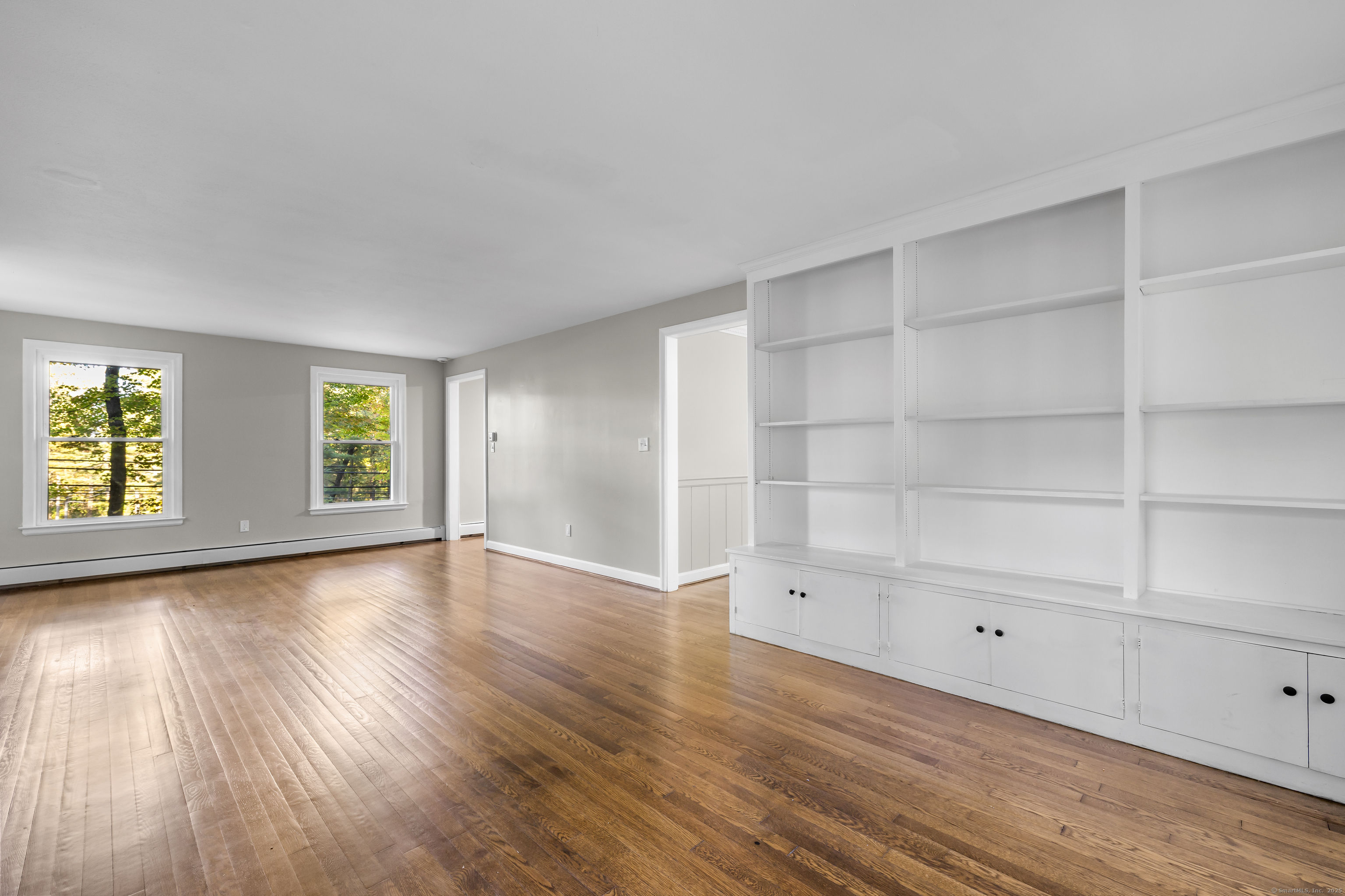 545 Simsbury Road Bloomfield, CT 06002 - Photo 17 of 39 a view of an empty room with wooden floor and a window
