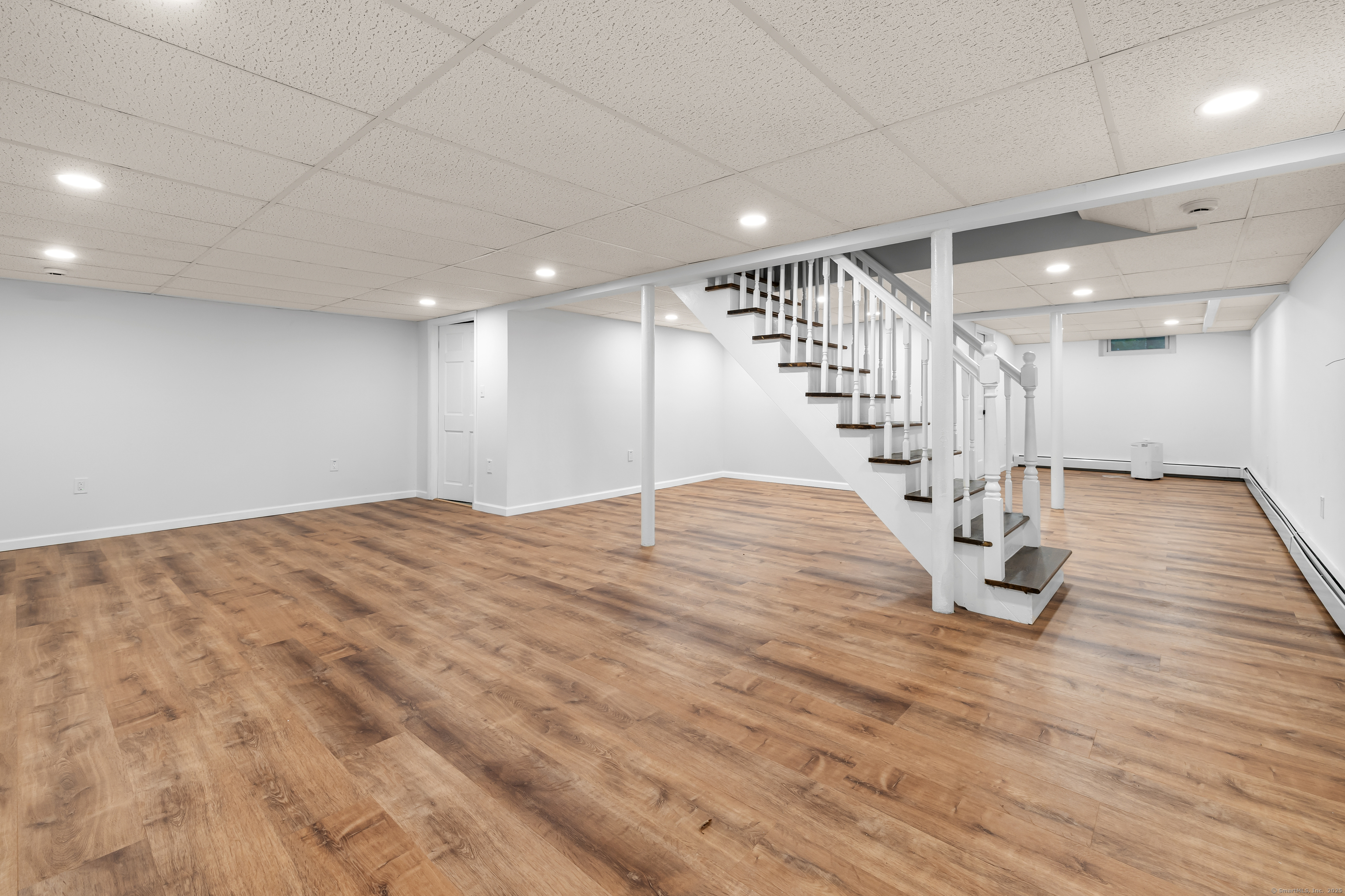 545 Simsbury Road Bloomfield, CT 06002 - Photo 18 of 39 a big room with stairs and a wooden floor