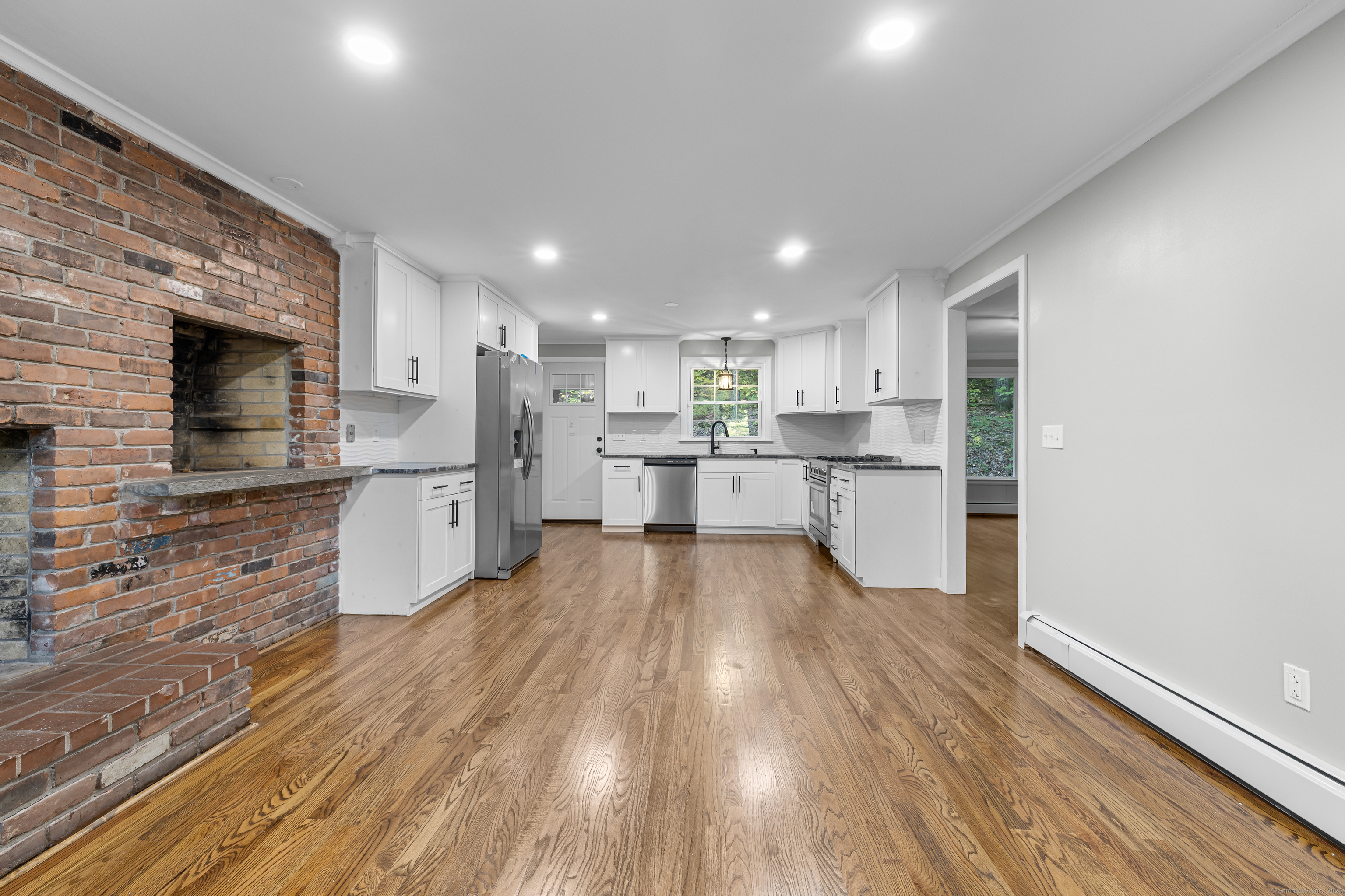 545 Simsbury Road Bloomfield, CT 06002 - Photo 2 of 39 a large kitchen with stainless steel appliances kitchen island a large counter top and a stove top oven